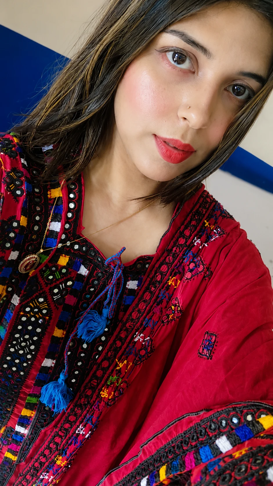 Zarqoon Saeed in a red embroidered kurta with mirror-work and tassel ties